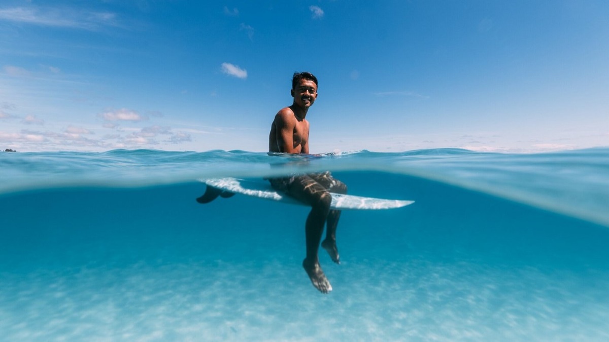 Surfer guest of Awera Resort waiting for the right wave Surfer guest of Awera Resort