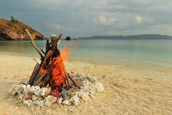 bonfire on a secluded island on honeymoon trip