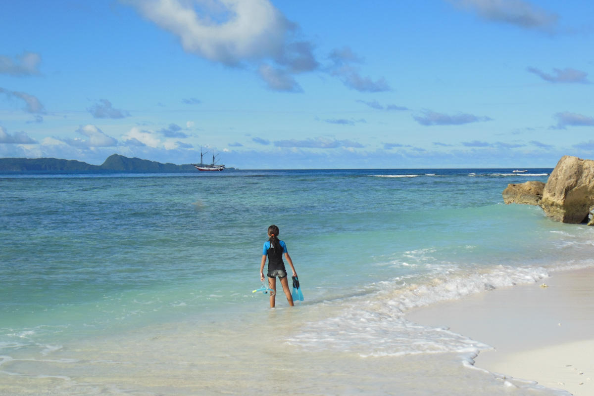 A kid snorkeler waits to be picked up by her liveaboard