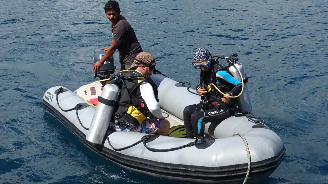 Scuba divers ready to jump into a dive site of Indonesia's Bird's Head Seascape